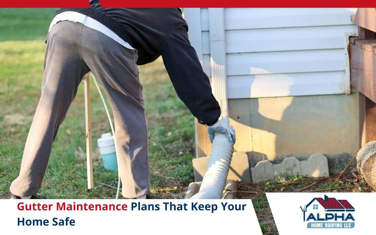 Professional checking downspout and fasteners during maintenance visit